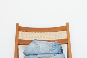 Comfortable sportswear folded on a wooden bench.